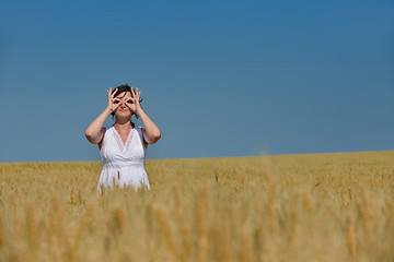 Image showing young woman in wheat field at summer