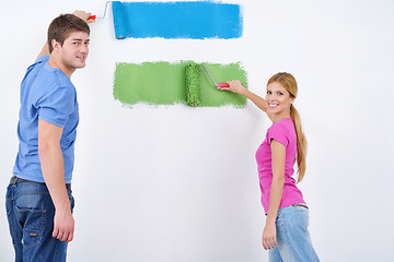 Image showing happy couple paint wall at new home