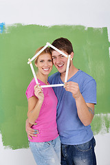 Image showing happy couple paint wall at new home