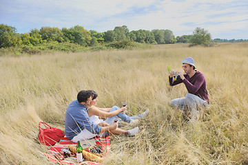 Image showing happy couple enjoying countryside picnic in long grass