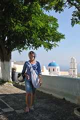 Image showing Greek woman on the streets of Oia, Santorini, Greece