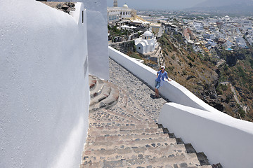 Image showing Greek woman on the streets of Oia, Santorini, Greece