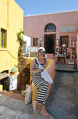 Image showing Greek woman on the streets of Oia, Santorini, Greece