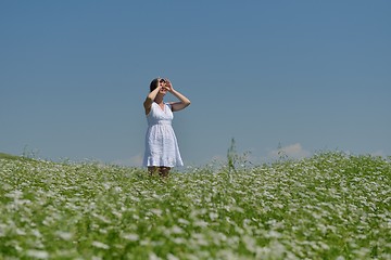 Image showing Young happy woman in green field