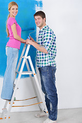 Image showing happy couple paint wall at new home