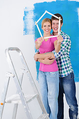 Image showing happy couple paint wall at new home