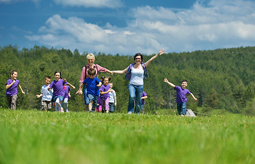 Image showing happy kids group with teacher in nature