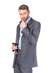 Image showing Portrait of thoughtful business man with glass wine