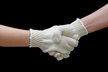 Image showing Labor handshake with safety gloves isolated on black