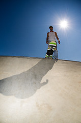 Image showing Skateboarder in a concrete pool 