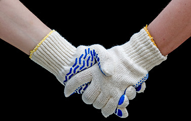 Image showing Labor handshake with safety gloves isolated on black