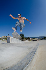 Image showing Skateboarder on a flip trick