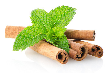 Image showing Cinnamon sticks and mint leaves