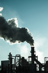 Image showing Smoking chimney  at sunset 