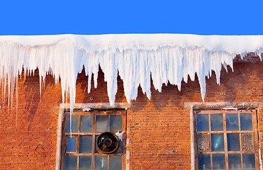 Image showing Snow cover on roof of old textile fabric with icicles