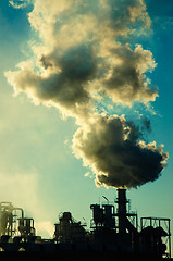 Image showing Smoking chimney  at sunset 