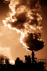 Image showing Smoking chimney  at sunset 