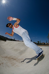 Image showing Skateboarder in a concrete pool 