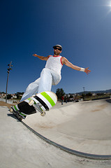 Image showing Skateboarder in a concrete pool 