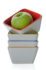 Image showing Colorful bowls with green apple