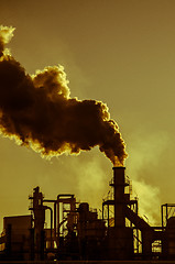 Image showing Smoking chimney  at sunset 