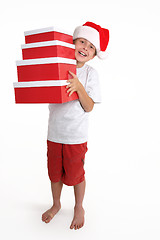 Image showing Child holding a stack of gift boxes