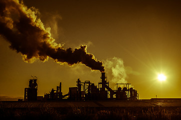 Image showing Smoking chimney  at sunset 