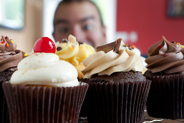 Image showing Man Looking at Cupcakes
