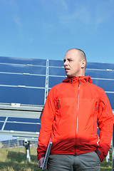 Image showing engineer using laptop at solar panels plant field