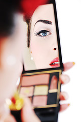 Image showing beautiful young woman applying makeup