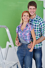 Image showing happy couple paint wall at new home