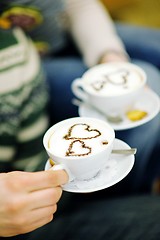 Image showing Young romantic couple relax on sofa in front of fireplace at hom