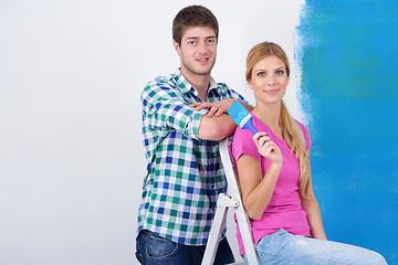 Image showing happy couple paint wall at new home