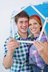 Image showing happy couple paint wall at new home