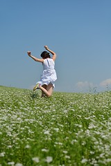 Image showing Young happy woman in green field