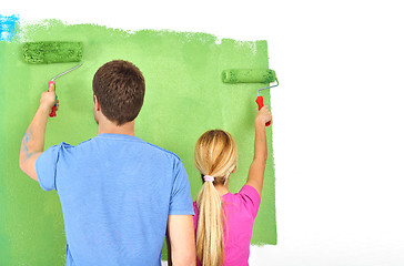 Image showing happy couple paint wall at new home