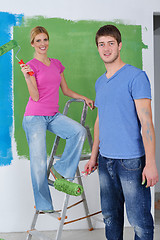 Image showing happy couple paint wall at new home