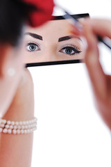 Image showing beautiful young woman applying makeup