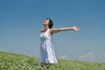 Image showing Young happy woman in green field