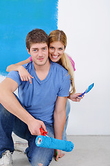 Image showing happy couple paint wall at new home