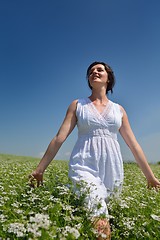 Image showing Young happy woman in green field