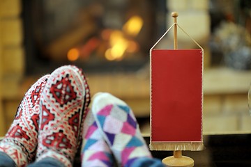 Image showing Young romantic couple relax on sofa in front of fireplace at hom