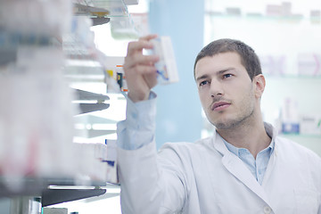 Image showing pharmacist chemist man in pharmacy drugstore