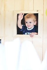 Image showing happy child in a window