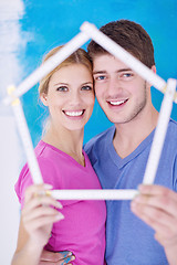 Image showing happy couple paint wall at new home