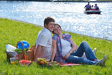 Image showing happy young couple having a picnic outdoor