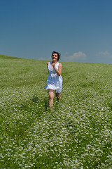 Image showing Young happy woman in green field