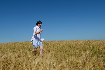 Image showing young woman in wheat field at summer