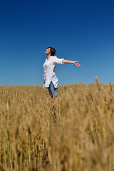 Image showing young woman in wheat field at summer