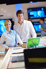 Image showing Young couple in consumer electronics store